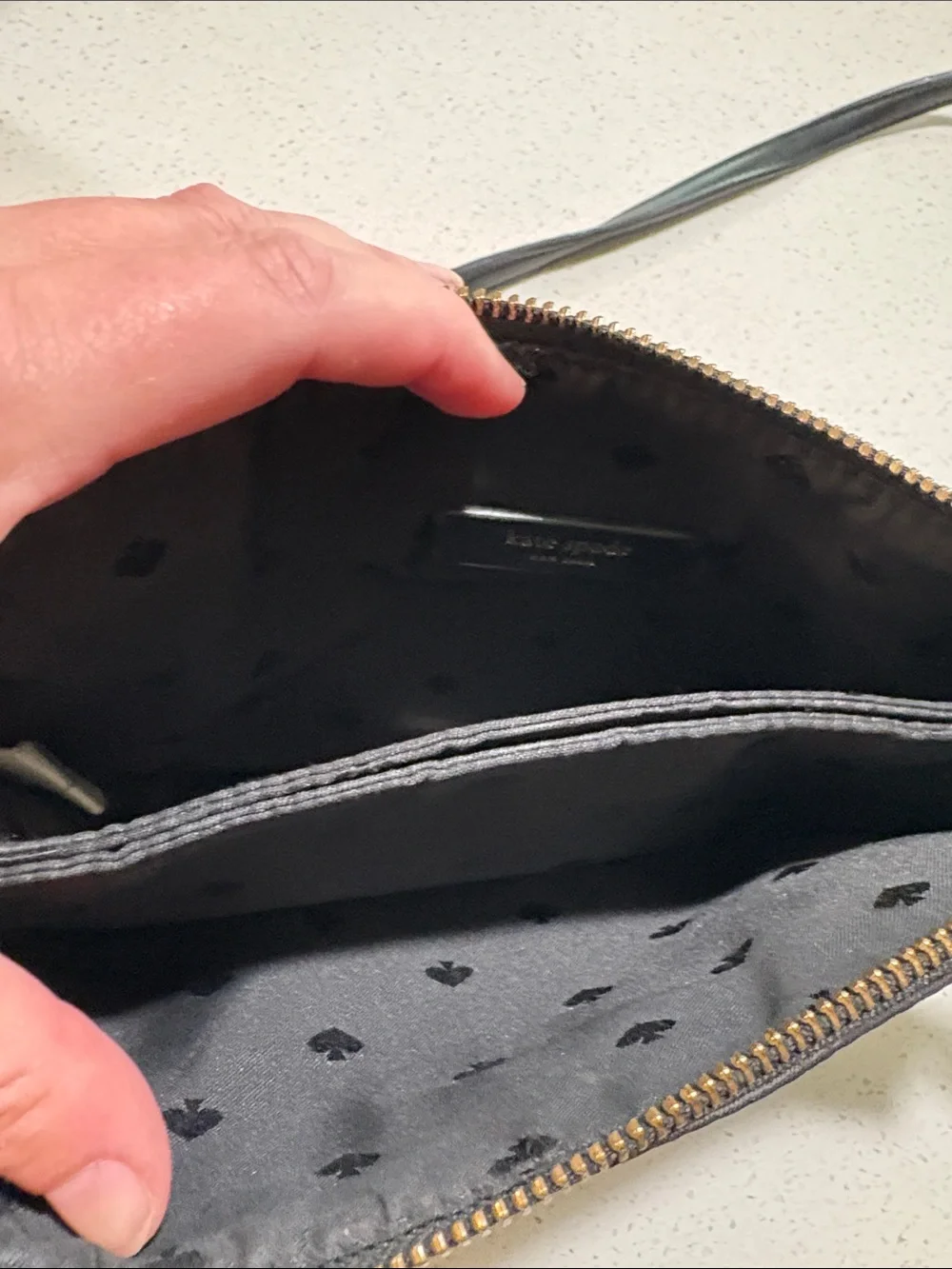 kate spade black crossbody pouch with gold-tone logo